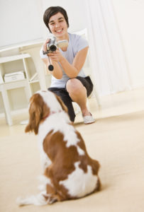 Woman Taking Picture of Dog